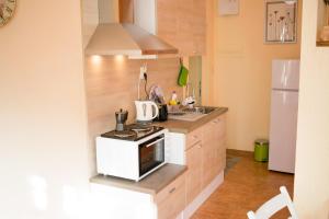 a small kitchen with a stove and a refrigerator at 4 Seasons apartments, A1 in Plovdiv +22 photos