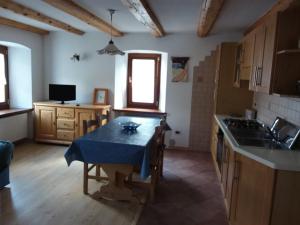 a kitchen with a table with a blue table cloth on it at Giovanna Ribul Moro in Padola