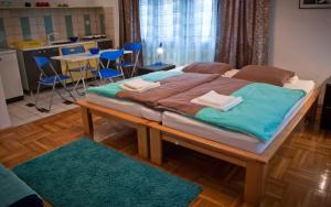 a large bed in a room with a kitchen at Guest House Ozon in Soko Banja