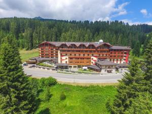 a large building in the middle of a road at Carlo Magno Hotel Spa Resort in Madonna di Campiglio