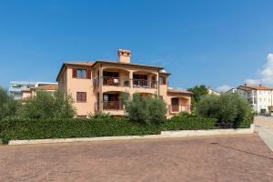 a large house on the side of a street at Apartments Radojka in Novigrad Istria