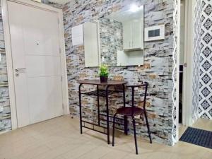 a kitchen with a table and a stone wall at Condo Unit walking distance to Manila Airport (NAIA Terminal 3) in Manila