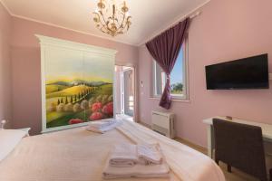 a bedroom with a large painting on the wall at Podere Abbazia b&b in Sinalunga