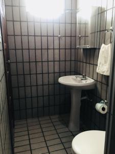 a bathroom with a sink and a toilet at Pousada Morro Bello in Morro de São Paulo