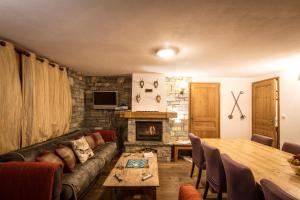 a living room with a couch and a table at Chalet Chardons Belvedere in Tignes
