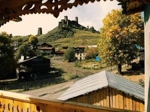 a view of a hill from a balcony with a house at Guesthouse Lasharai in Omalo
