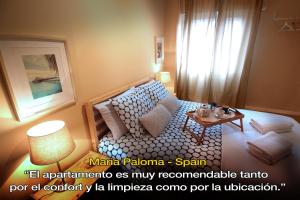 a small room with a bed and a table at LivingPorto Boavista in Porto