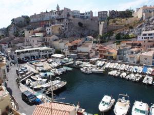 a bunch of boats are docked in a harbor at Home Opéra in Marseille