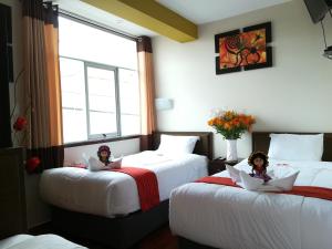 Postel nebo postele na pokoji v ubytování Pumas Cusco Hotel