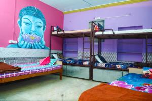 a room with three bunk beds with a large head on the wall at Royal Heritage Guest House in Jodhpur