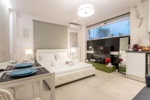 a large bedroom with a white bed and a table at Stadium HiEnd Studio Top Location in Athens