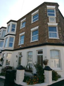 a brick building with flowers in front of it at Rosslyn Court in Margate