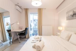 a white bedroom with a desk and a bed at Stadium 1bdr HiEnd quiet Flat Top Location in Athens