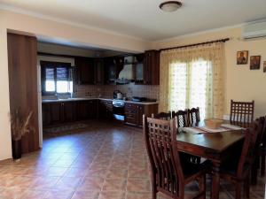 a kitchen and dining room with a table and chairs at Meda House in Kiparission