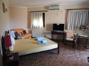 a room with a bed and a couch and a tv at Meda House in Kiparission