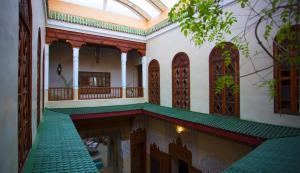 a building with a pool in the middle of it at Riad Dar Zaya in Marrakesh