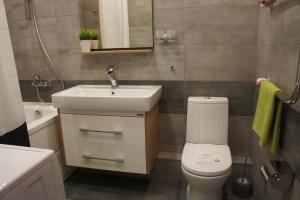 a bathroom with a white sink and a toilet at Astoria Club in Oryol