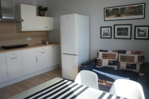 a kitchen with a table and chairs and a refrigerator at Astoria Club in Oryol