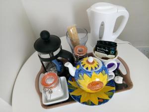 a table with a tea pot and a coffee maker at Rosslyn Court in Margate