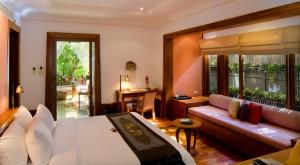a hotel room with a bed and a couch at Nakamanda Resort and Spa in Klong Muang Beach +127 photos