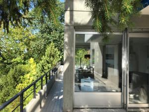 a glass house with a view of the garden at Ferienwohnung-Freiburg-Exklusiv in Freiburg im Breisgau