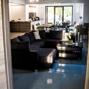 a living room with a couch and a table at Pensiunea Negoiu in Porumbacu de Sus