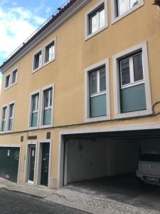 a building with a garage in front of it at Prime Location - Historic District with Private Parking in Lisbon