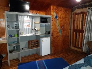 a kitchen with a white refrigerator in a room at Thandamanzi Self Catering in Sabie