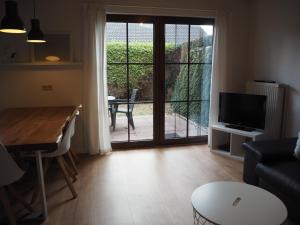 a living room with a view of a patio at Ferienhaus Mundan 2 in Burhave