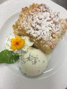 a plate of food with a piece of cake and ice cream at Centrum25 in Olsztyn