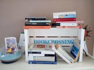 a pile of books sitting on top of a shelf at B&B Fermo d'A Mare in Fermo