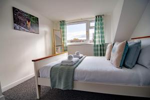 a small bedroom with a bed with a window at Wells Street Cottages No 26 By The River Ness in Inverness