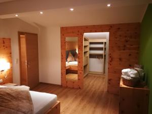 a bedroom with a wooden wall with bunk beds at Ferienwohnung La-Wurm in Hart im Zillertal