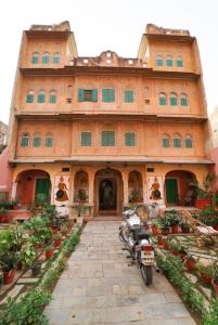 un edificio con una motocicleta estacionada frente a él en Jaipur Haveli en Jaipur