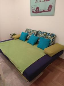 Bett in einem Zimmer mit blauen Kissen darauf in der Unterkunft Your Place in Zagreb in Zagreb