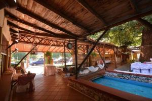 a pavilion with a swimming pool in a house at Lydia Hotel in Krinídhes