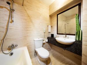 a bathroom with a sink, toilet and bathtub at Village Hotel Albert Court by Far East Hospitality in Singapore