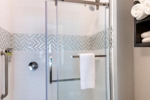 a shower with a glass door in a bathroom at Staybridge Suites - Lake Charles, an IHG Hotel in Lake Charles