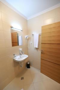 a bathroom with a sink and a mirror at Hotel Banja Luka in Banja Luka