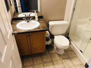 a bathroom with a toilet and a sink at Quiet 2 Bed 2 Bath close to Westview Hospital in Stony Plain