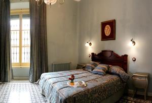 a bedroom with a bed with a table on it at Casa Rural Doña Elisa in Torrenueva