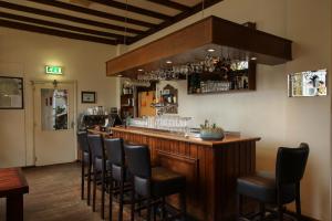 a bar with a bunch of chairs around it at Hotel de Abdij in Horn