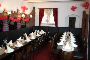 a row of tables and chairs in a room with red balloons at Hotel Restaurant Balkan in Trier