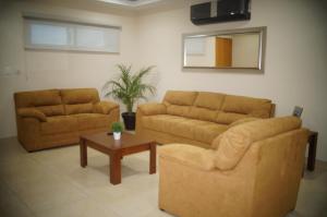 a living room with two couches and a coffee table at Casa Luna Suites in La Paz
