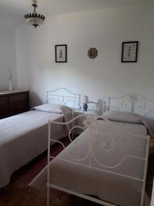 En eller flere senge i et værelse på A Casinha