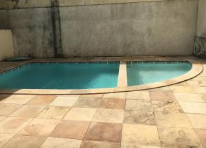 an empty swimming pool with a tile floor at Roma Garden in São Luís