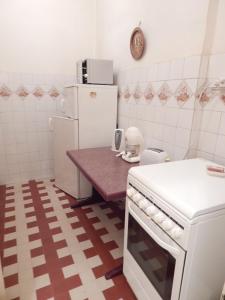 a kitchen with a refrigerator and a table in it at City Center Apartment in Budapest