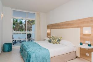 a bedroom with a bed and a large window at Gara Suites Golf & Spa in Playa de las Americas +84 photos