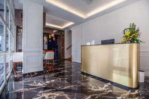 a lobby with a large screen on a marble floor at White Mansion Penang in George Town