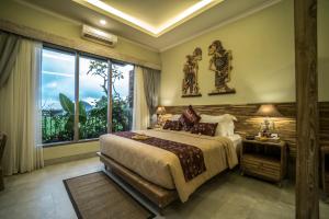 a bedroom with a large bed and a large window at Villa Kirani Ubud by Mahaputra-CHSE Certified in Ubud